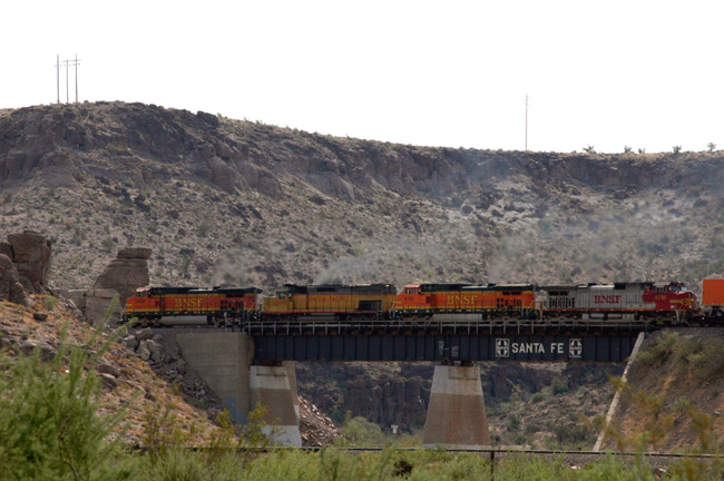 3 BNSF diesels and 1 UP tunnel motor diesel passing bridge in Kingman Canyon, AZ
