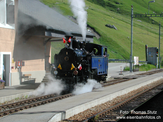 Dampflok Furka-Bergstrecke
Überraschende Begegnung (auf der Durchreise) mit der Lok HG 3/4 Nr. 1 der Dampfbahn Furka-Bergstrecke. Die Lok fährt nach Andermatt, um dort einen Extrazug zum Jubiläum "75 Jahre Eisenbahn am Furkapass" zur direkten Fahrt nach Gletsch zu übernehmen.
