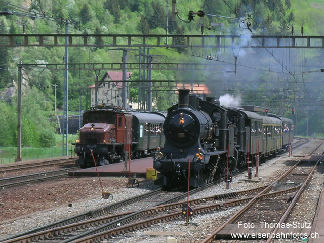 Parallelausfahrt
Während der Dampfzug den Bahnhof durchfährt, setzt sich auf der Extrazug mit dem Krokodil langsam in Bewegung.
